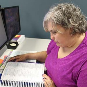 Student working in a Health Informatics Textbook