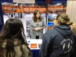 Ditch Witch employee visits with two students
