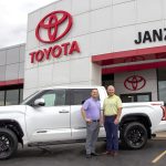 Janzen Sales Manager and Owner pose with truck in front of Janzen Toyota. Janzen Toyota of Stillwater is sponsoring the hole-in-one competition at the golf tournament.